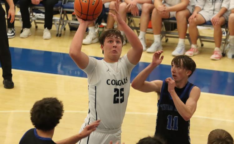 Top- Cross County junior Gabe Nuttelman (25) squares up for this short jumper against Twin River on Monday night in the CRC quarterfinals at the York University. PCN photo by Ken Kush