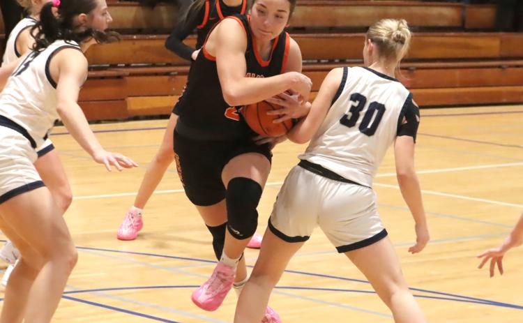 Osceola’s Bella Recker hits the hole like a running back in Friday’s CRC Championship game. Recker led the Bulldogs with 16 points, but the Bulldogs fell short of winning the title 42-40. PCN photo by Ken Kush.