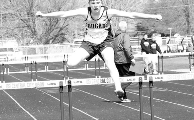 Wyatt Hengelfelt clears the last hurdle in the 300-meter hurdles for the Cougars.