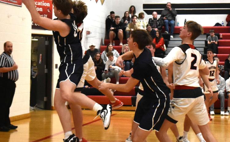 Langdon Arbuck pulls down a rebound against Sutton. PCN photo by Beth Sparrow.
