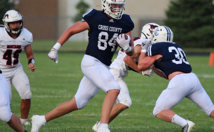 Tanner Hollinger runs the ball as Izaac Dickey blocks. PCN photo by Travis Lane.