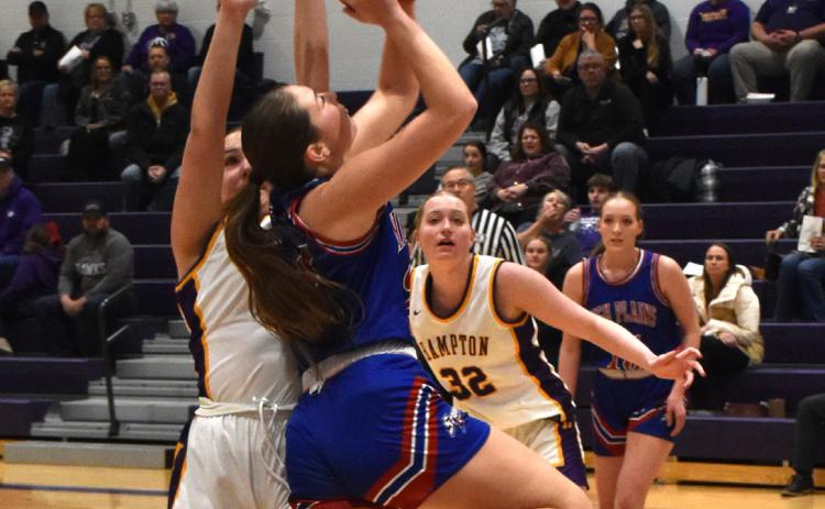 Rylee Ackerson goes for a shot as a Hampton girl tries to stop her. PCN photo by Beth Sparrow.