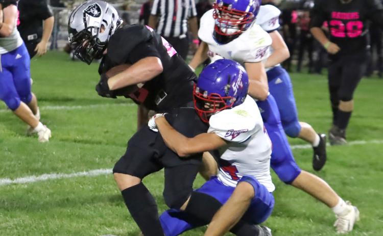 High Plains Colin Howell (14) drags down Lawrence-Nelson junior Jackson Williams (22) following a short run. Williams scored in the first quarter on a 45-yard punt return. PCN photo by Ken Kush.