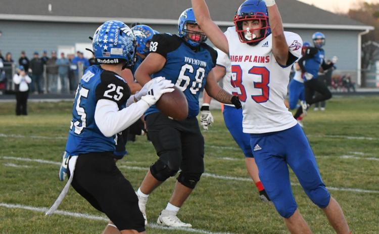 Carter Urkoski goes for the block as Overton tries to pass. PCN photo by Rick Holtz.