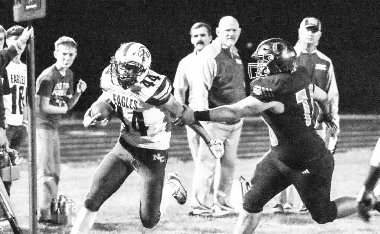 Osceola’s Brenden Gabel (78) reaches out and tries to grab the Nebraska Christian ball carrier in the Bulldogs 54-24 win over the Eagles Friday night. PCN photo by Blaine Winslow