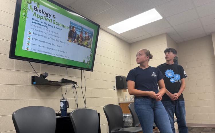 Madison Augustin and Garrett Ruth discuss the greenhouse proposal. PCN photo by Rick Holtz.