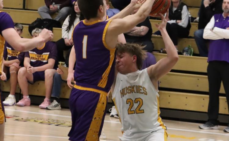 Shelby-RC sophomore Jaxson Thompson (22) is knocked to the floor as he and Tekemah-Herman’s Kash Kellogg fight for the ball. PCN photo by Ken Kush.