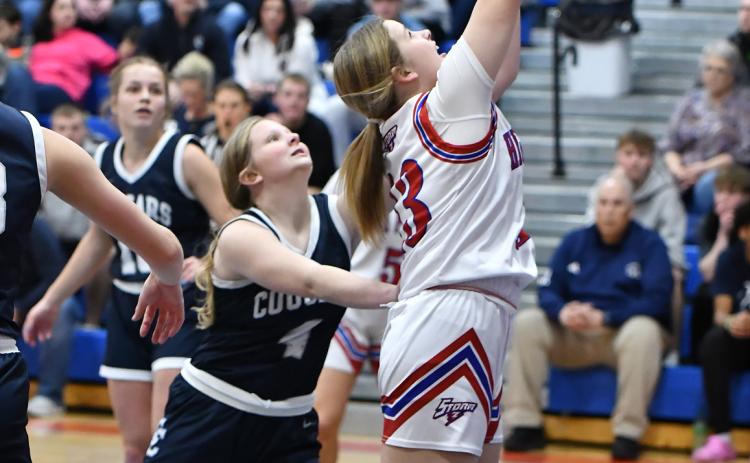 Above: Makenna Fuhrman (HPC) takes it to the basket as Beretta Webb (CC) tries to stop her. PCN photo by Rick Holtz. Below: Olivia Frederick shoots one against Nebraska Christian. PCN photo by Beth Sparrow.
