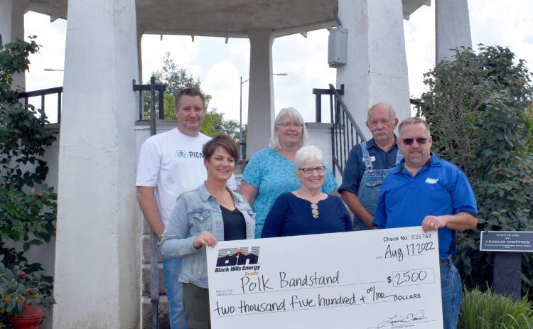 Pictured are representatives from Black Hills Energy presenting the check to the Polk Bandstand committee: (Front row L to R) Mindy Mertz, Karen Stevens, and Jeff Hohnholt (back row) Nick Hatfield, Kathie Carlstrom and Dean Thomas. PCN Photo by Beth Sparrow.