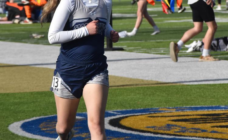 Above: Kylie Moore runs the 1600m. PCN file photo by Beth Sparrow.