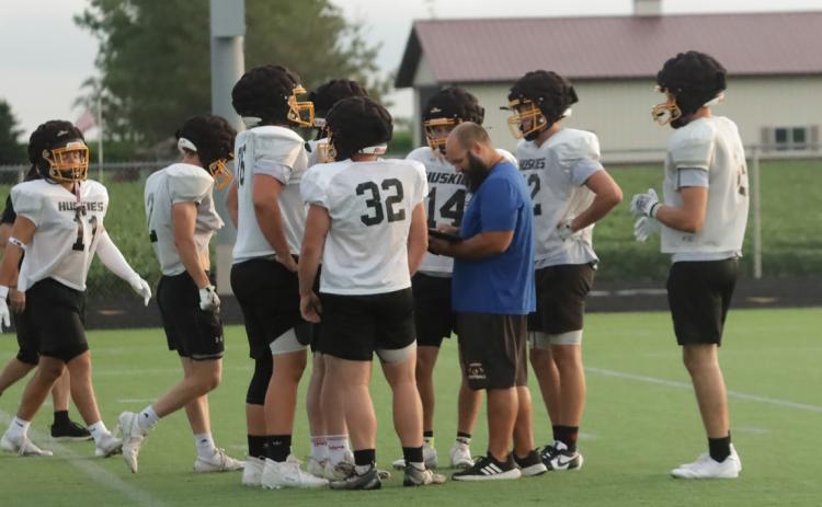 Shelby-RC head coach Zach Kubik works with the offense during an early Thursday morning workout as they prepare for their season opener at Freeman just a little over a month away. PCN photo by Ken Kush.