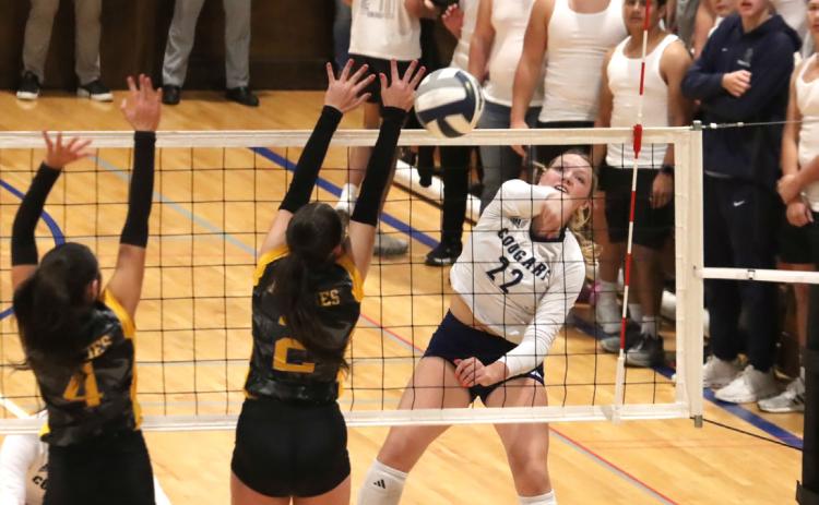 Above: Sydney Hengelfelt was key for the Cougars with 27 kills in the championship match. Here she sends one by Brooklyn Baker and Kendall Nickolite.