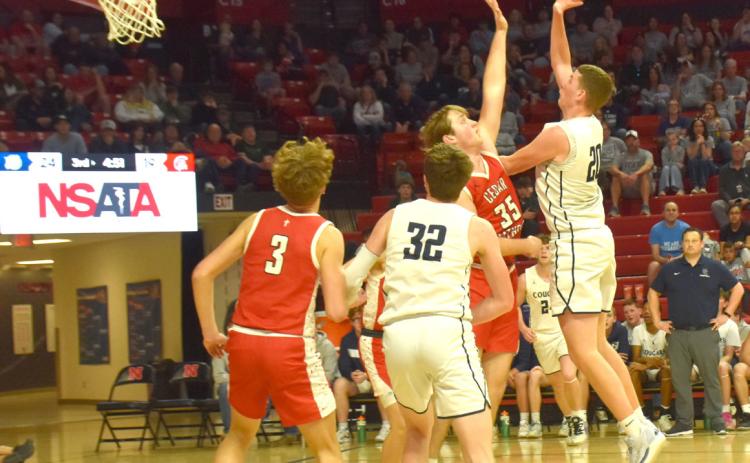 Above: Brock Allen goes for a rebound against Cedar Catholic. PCN photo by Beth Sparrow.