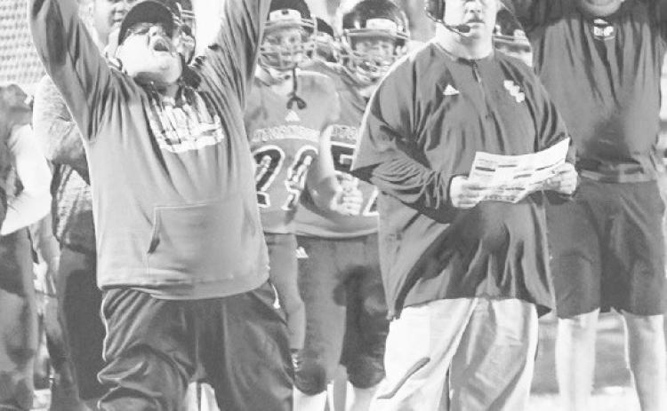High Plains-Osceola Stormdogs co-head coach Robert Fuller celebrates the game winning touchdown in the team’s semifinal win over Cross County. In the middle is co-head coach Greg Wood and far right extending his arms is assistant coach Andy Roberts.The Stormdogs would go on to defeat Burwell in the D-1 State title game. Photos from PCN files.