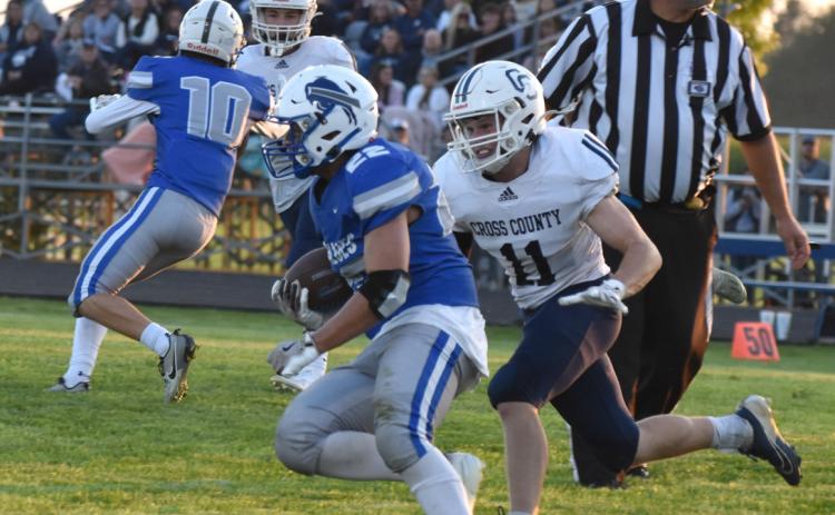 Above-Cross County’s Jed Berggren (11) pursues the Gibbon ball carrier in Friday night’s game on the road in Gibbon. Berggren was second on the team with 10 tackles in the win. PCN photo by Beth Sparrow
