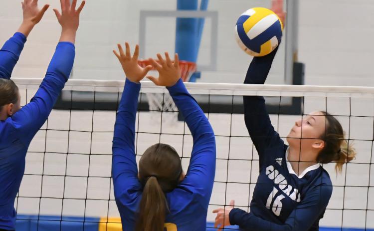 Cross County junior Ava Pruter (16) slams the attack into the Morrill Lions frontline defense during Saturday’s D1-4 final at Morrill High School. Pruter led the Cougars with 22 kills as Cross County earned their first state volleyball berth since 2022. Photo by Sandy Thompson.
