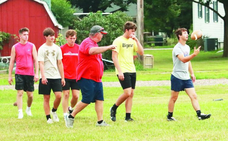 Coach Greg Wood (center) head coach of the of the High Plains Storm talks with his players as they practice for the upcoming inagural season of six-man football at High Plains. PCN photo by Ken Kush