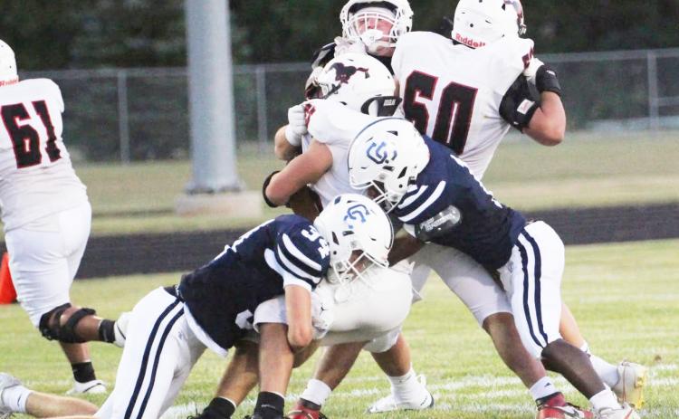 Top-Cross County’s defense collapses on the Sutton ball carrier. The Cougars had their hands full with a potent Sutton rush attack. Above-Eli Greenwall (3) looks for running room. PCN photos by Travis Lane.