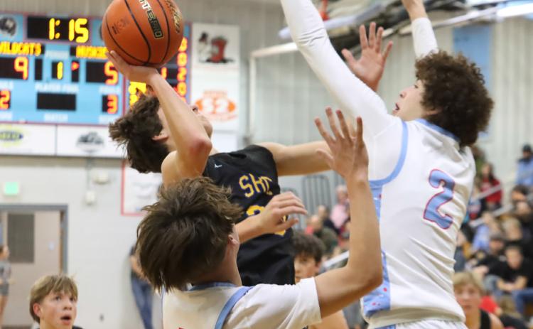 Junior Nixon Thelen (30) is able to get into the paint and draw the foul during second quarter action at Cedar Bluffs on Friday. Nixon led the SRC boys with 18 as the topped the Wildcats 4630. PCN photo by Ken Kush.