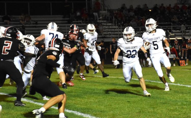Thatcher Hanson runs the ball as Tony DeWitt blocks for him. Hanson broke two school records on Friday. PCN photo by Beth Sparrow.