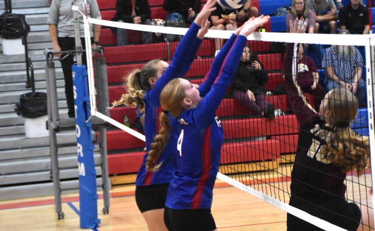 The Hofmann sisters (Rylee and Peyton) go up for the block against East Butler. PCN photo by Beth Sparrow
