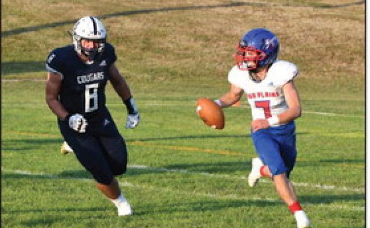 Haden Helgoth scrambles out of the pocket. PCN photo by Rick Holtz.