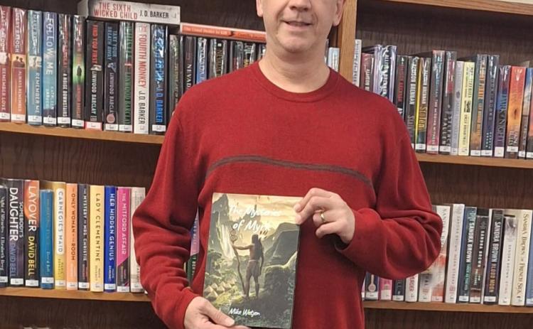 Left: Mike Wetjen of Shelby is pictured with his book in the Shelby Community Library.