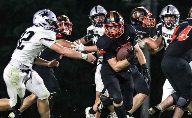 Above- Osceola senior fullback Aden Feezell breaks from the pack during the Bulldogs Friday night game in Osceola against the Elmwood-Murdock Knights. Feezell led the team in rushing with 77 yards on six carries and he also had a team-high 19 tackles.