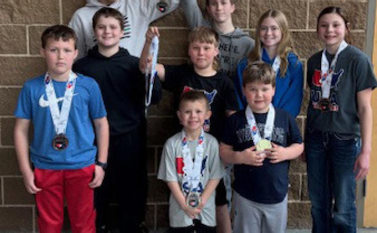 Above: Cross County junior high and Little Cougars qualified for state in wrestling. Pictured are (back) Bridger Johnson, Bode Berggren, Piyper Berggren and Rowan Bowman; (front) Fisher Johnson, Tragen Bowman, Gage Berggren, Easton Carlson and Barrett Bowman. Below left to right: Leland Rice and Sarah Carnes from Osceola.