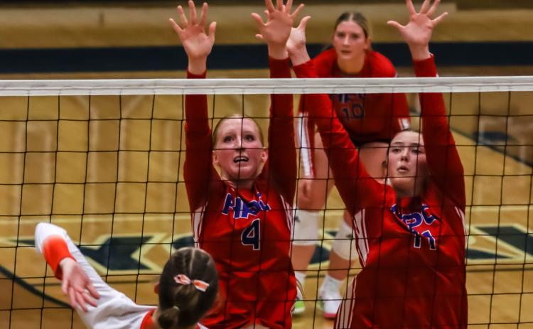 Peyton Hofmann and Rylee Ackerson go up for the block for the Storm against Dorchester in CRC play. PCN photo by Blaine Winslow.