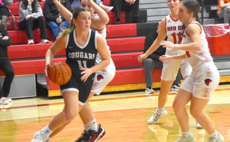 Cross County senior Ella Clark navigates the baseline as the David City defense closes in. In her second game back after a foot injury Clark scored 10 in the win over David City and 10 against Twin River. PCN photo by Beth Sparrow.