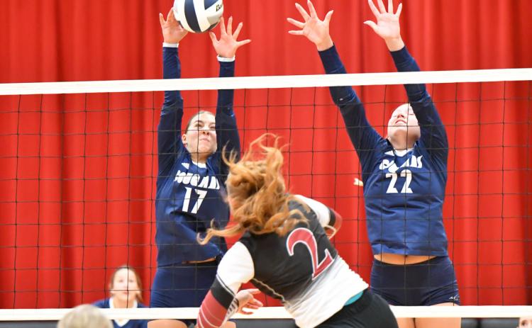 Top: Cross County sophomore Saphira Osentowski (17) and senior Sydney Hengelfelt (22) set up the block in last Thursday night’s game at Fullerton won in three sets by the Cougars.