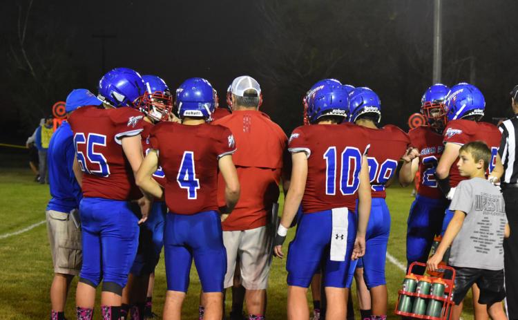 The High Plains Storm football team meets with head coach Greg Wood during a time out Friday night. The Storm dealt with a large number of injuries during the season, but somehow made it to the end of the year and played every game on their schedule. PCN photo by Beth Sparrow