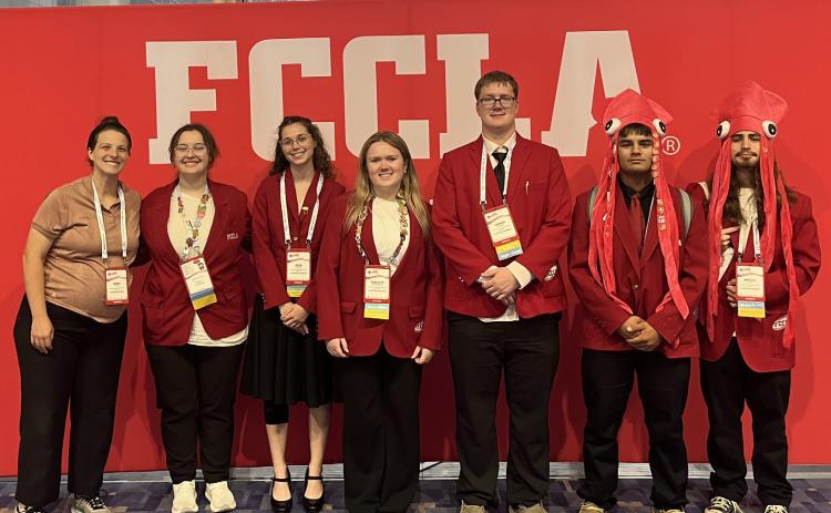 Above: Cross County FCCLA went to Washington, DC for national conference. Pictured are Sarah Hubel (advisor), Olivia Tandy, Julia Stewart, Gracelyn Everingham, Cannen Mooney, Caleb Troy and Brad Lott. Below: State officer Paxton Burke presents. Photos provided.