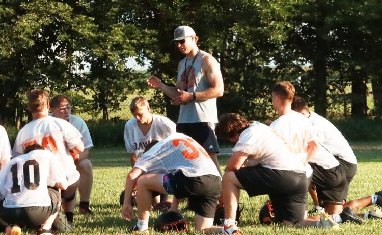 Osceola Football head coach Luke Ericson talks witht the team following summer camp practice on Tuesday night. Ericson and his staff returns strong offensive options while having to replace both offensive and defesnive lineman. PCN photo by Ken Kush.