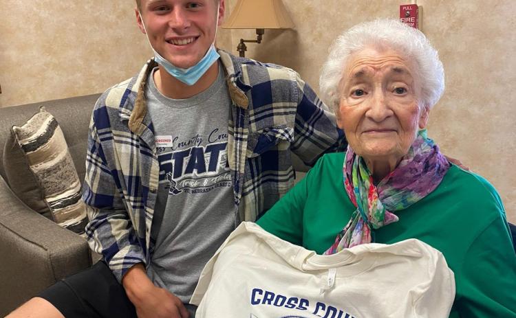 Donna is pictured with her great-grandson Jackson and her new Cross County t-shirt donated by the Cross County Booster Club. Photo provided by Erin Dickey.