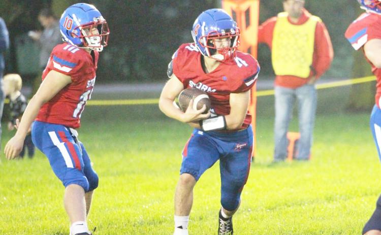 High Plains senior Aaron Brown takes the hand-off from senior QB Carson Swedenburg. Brown ran for two scores, caught a TD pass and was named Homecoming King. PCN photo by Travis Lane