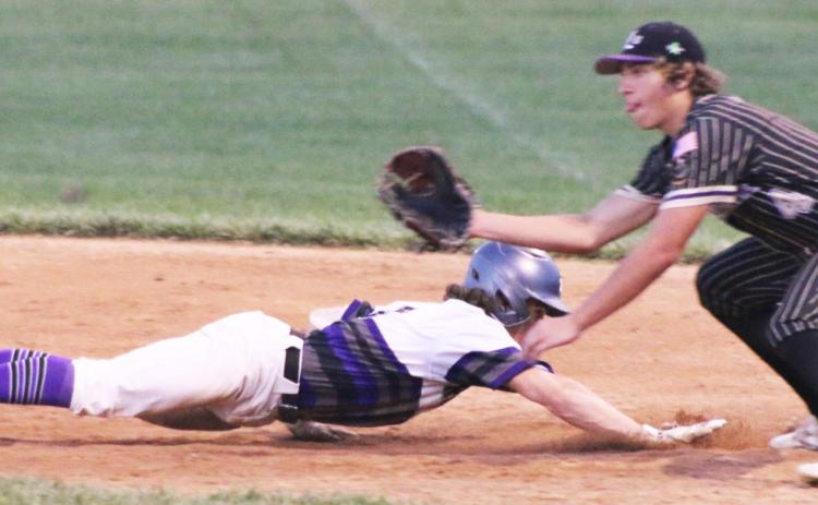 Grady Belt safely dives back to first base Friday during the York Cornerstone Bank Tournament. Photos by Tara Urkoski