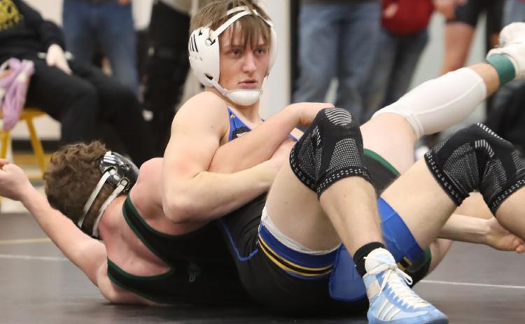 Top left- Junior Jett Vrbka improved to 15-0 as he won the 175-pound bracket at the SRC Invite.