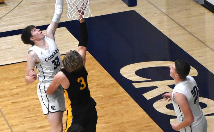 Wyatt Hengelfelt (CC) takes the ball up to the basket as Dalton Pokorney (SRC) defends. PCN photo by Beth Sparrow.