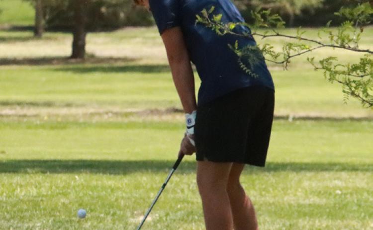 Cross County’s Gabe Nuttelman chips from behind the No. 9 green in Geneva during the CRC Tournament. PCN photo by Ken Kush