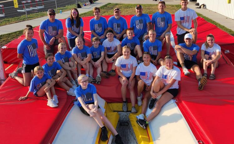 Janna Roberts (second row, fourth from left) is part of the Sky High Pole Vault Club based out of Aurora. Also pictured is Coach Luke Ericson (back row, second from left). The Aurora street vault is Saturday June 24 for high schoolers. Photo provided.
