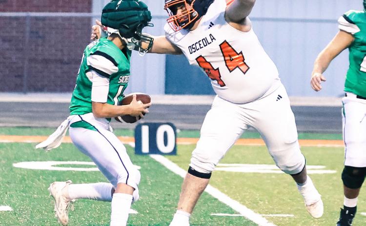 Osceola senior defensive end Cooper Yungdahl records one of his two sacks in the Bulldogs district opener at Falls City Sacred Heart. PCN photo by Blaine Winslow.