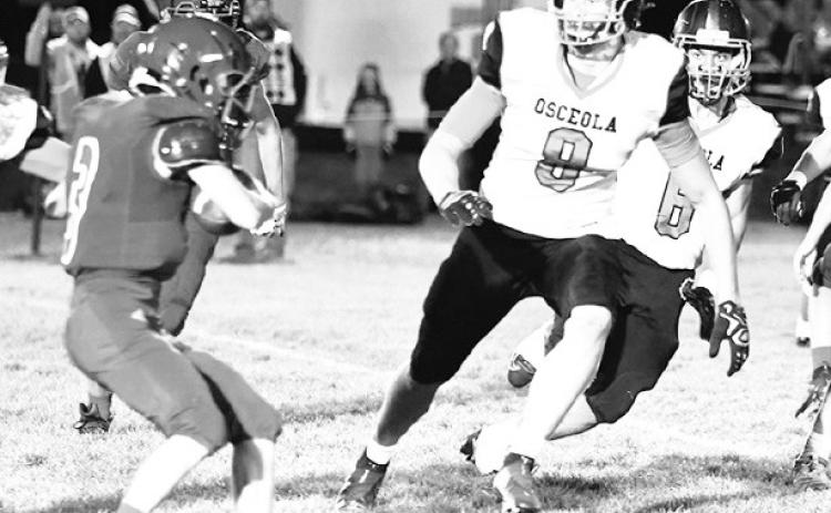 Osceola’s Kyle Sterup (8) closes in defense as High Plains back Tanner Wood looks to make a cut. PCN file photo.